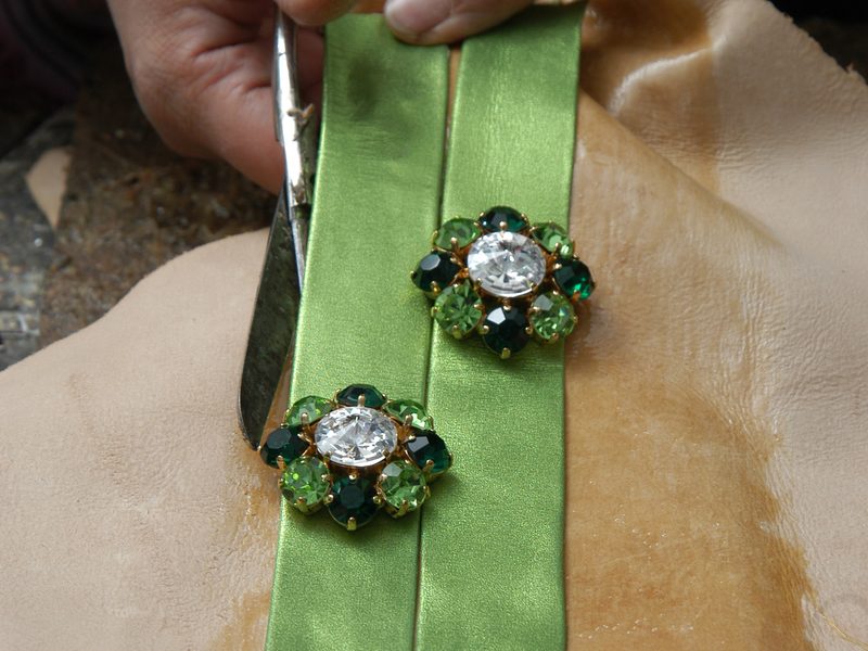 Jewelled ornaments laid on straps, ready to be chosen
